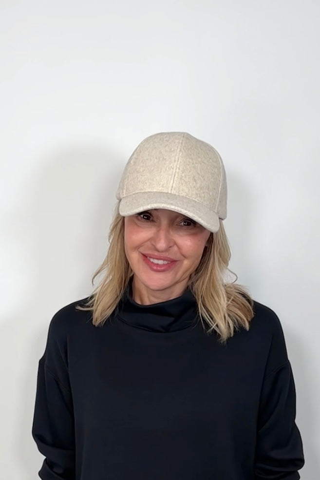 Front view of a woman wearing an oat coloured baseball felt hat
