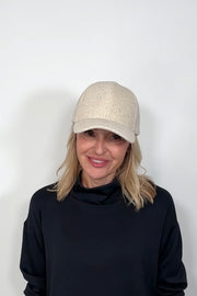 Front view of a woman wearing an oat coloured baseball felt hat