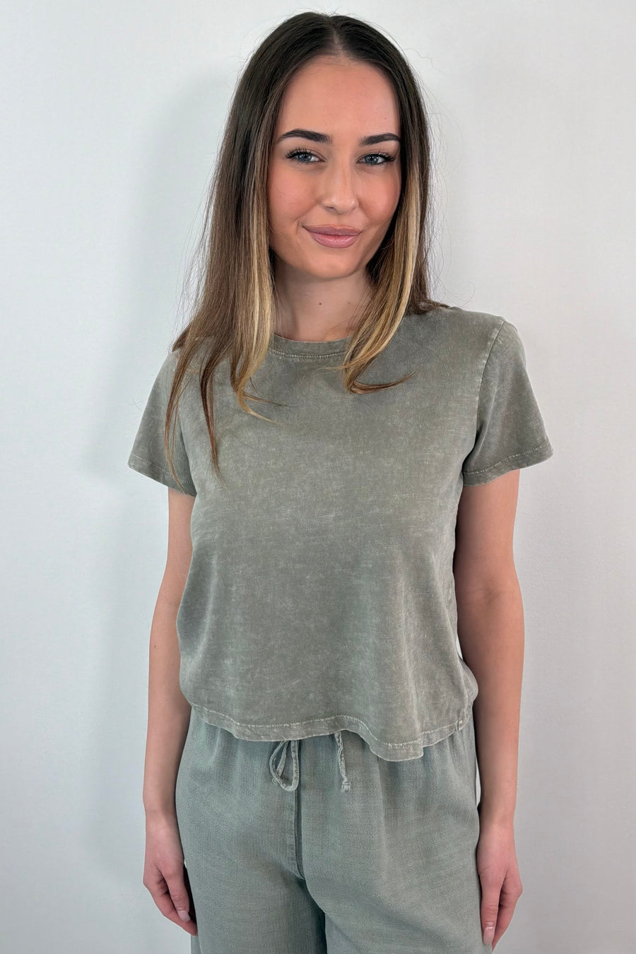 Woman wearing a green short sleeved t-shirt