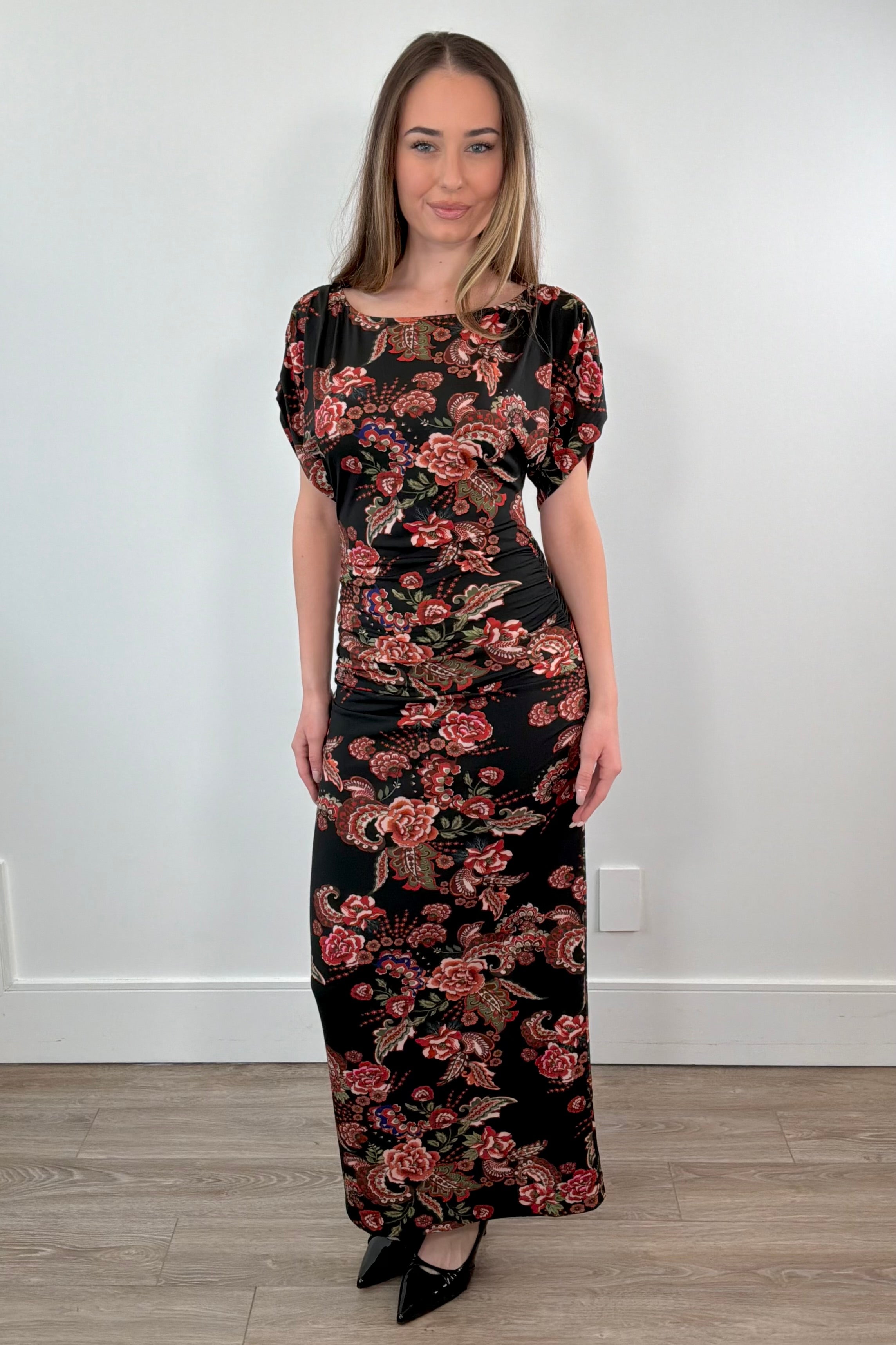woman wearing a maxi rouched floral dress 