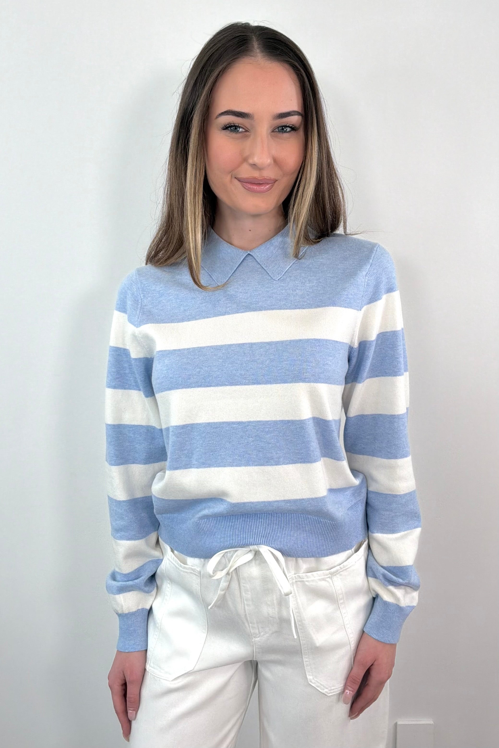 woman wearing a blue and white striped polo sweater