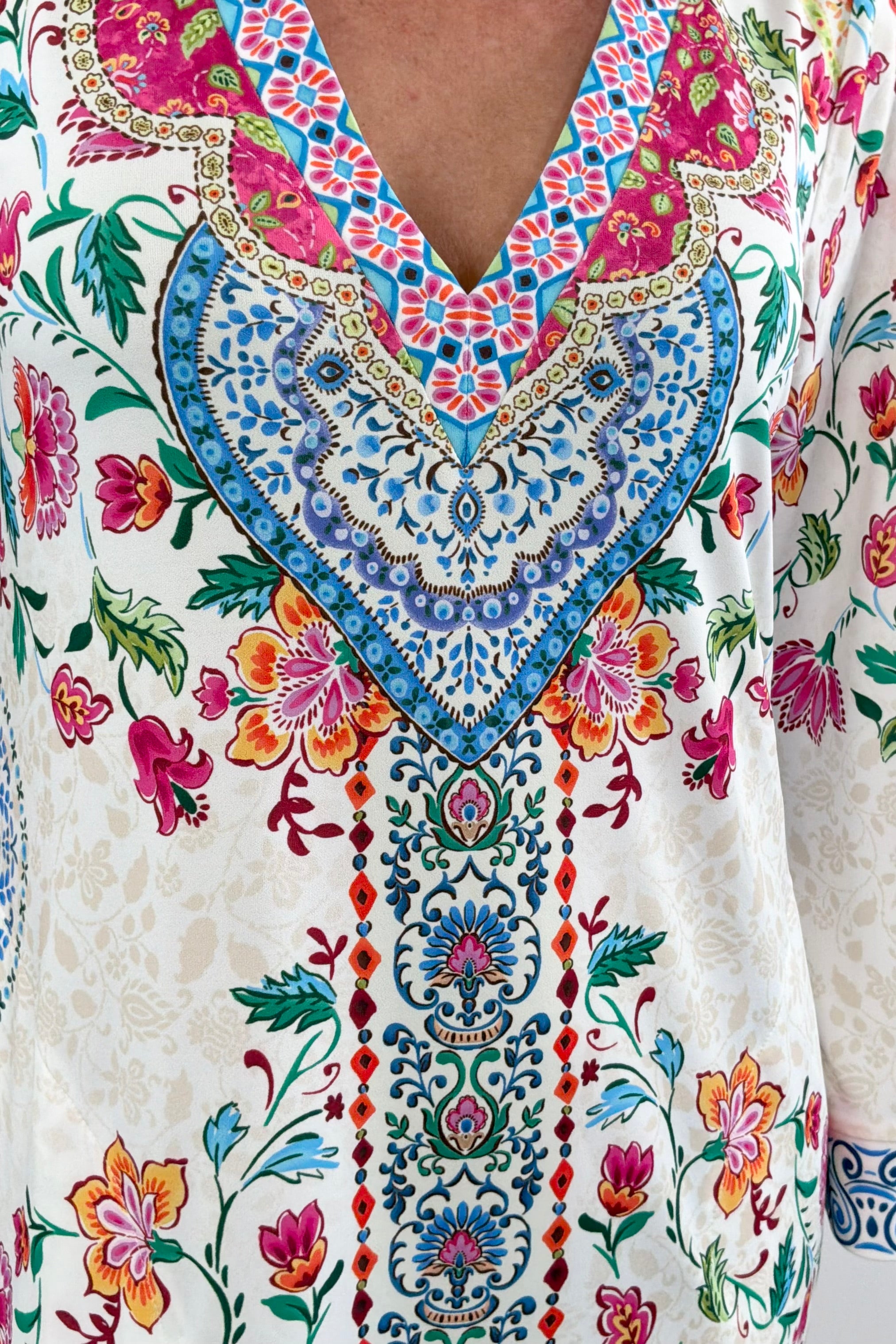 Woman wearing a colorful floral v-neck dress