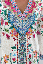 Woman wearing a colorful floral v-neck dress