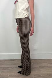 Side view of woman wearing a houndstooth print knit pant