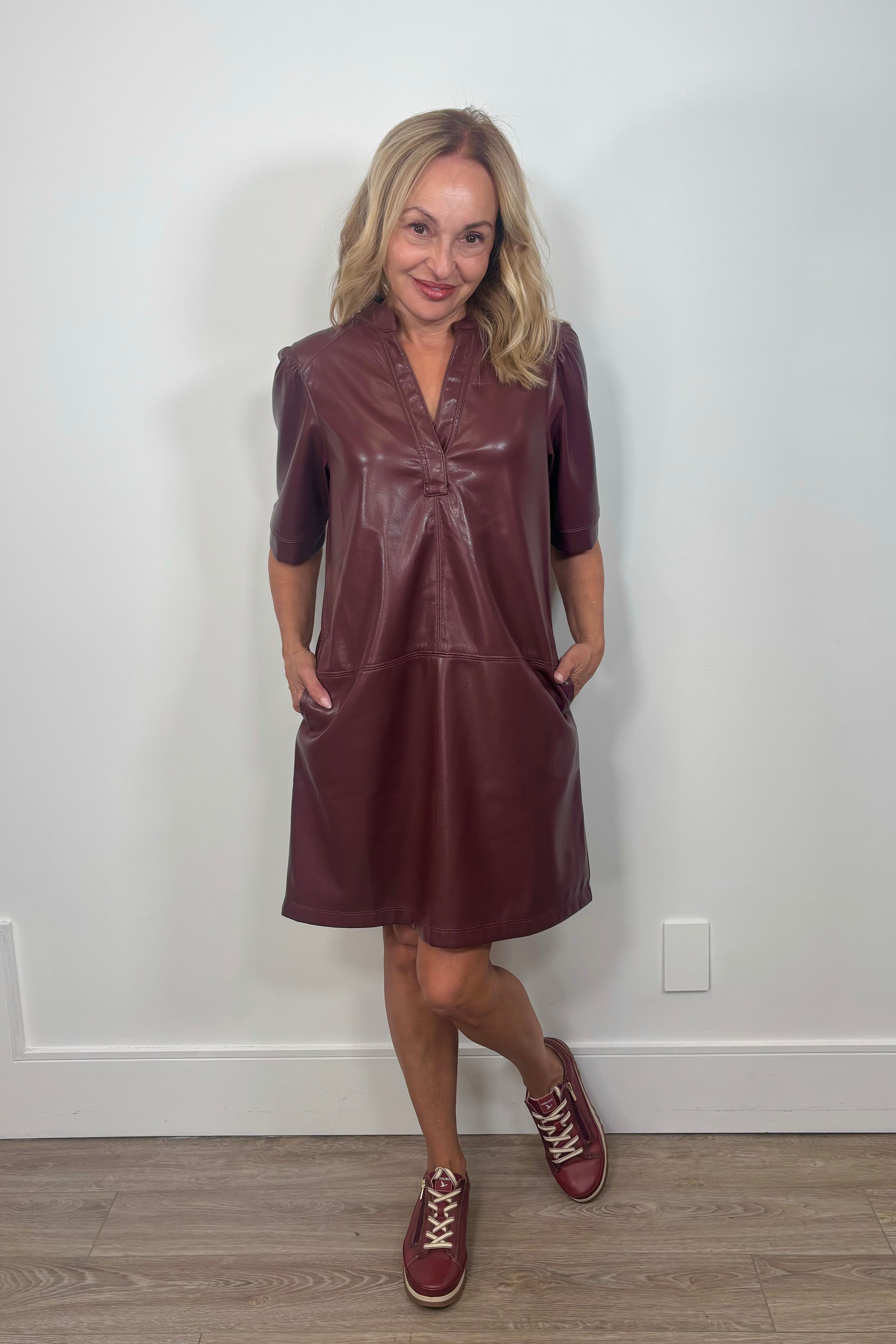 woman wearing a dark burgundy leather short dress