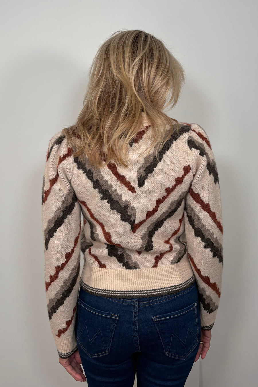 Back view of woman wearing a jacquard pattern sweater