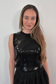 woman wearing a black sequin tank top