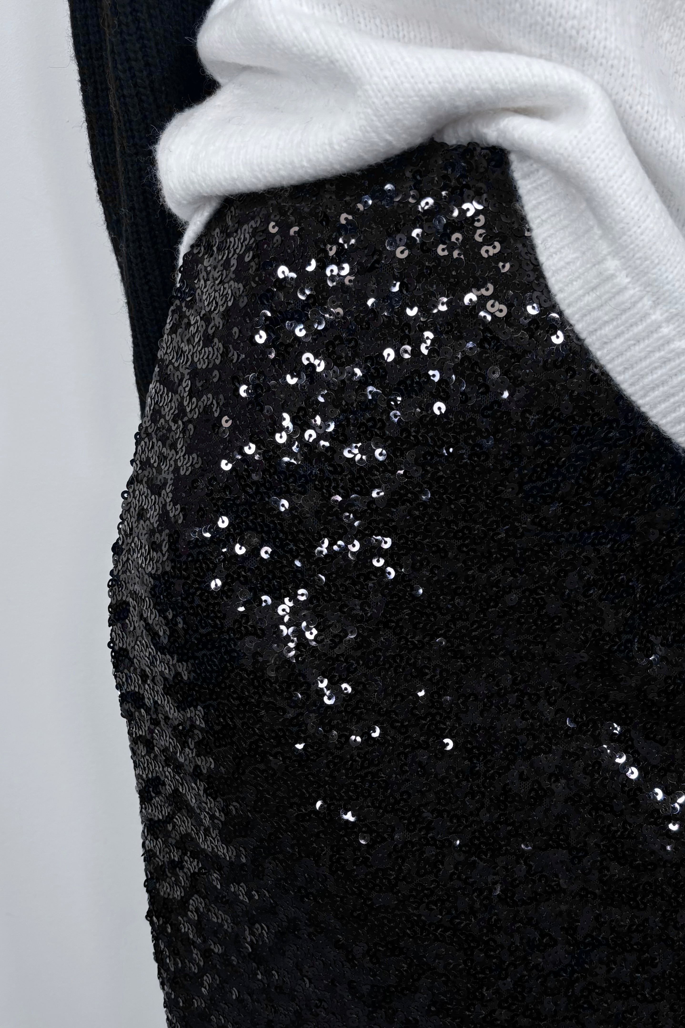 Close-up of a black midi sequin skirt