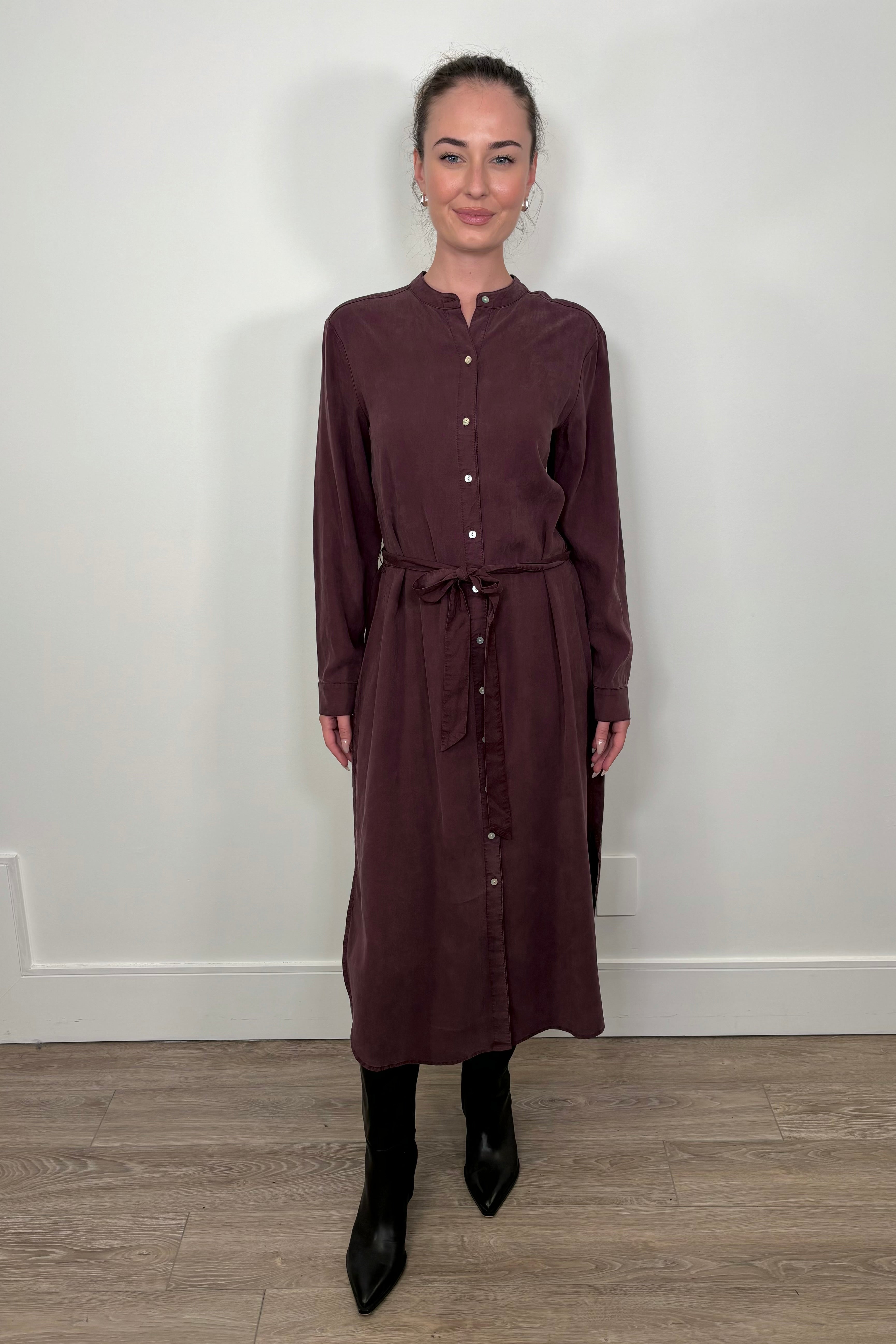 Front view of a woman wearing a maxi long sleeve button down shirt dress