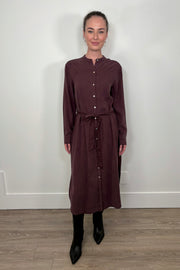 Front view of a woman wearing a maxi long sleeve button down shirt dress