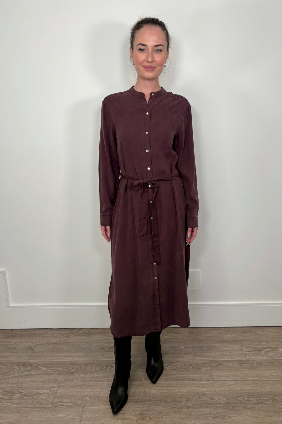 Front view of a woman wearing a maxi long sleeve button down shirt dress