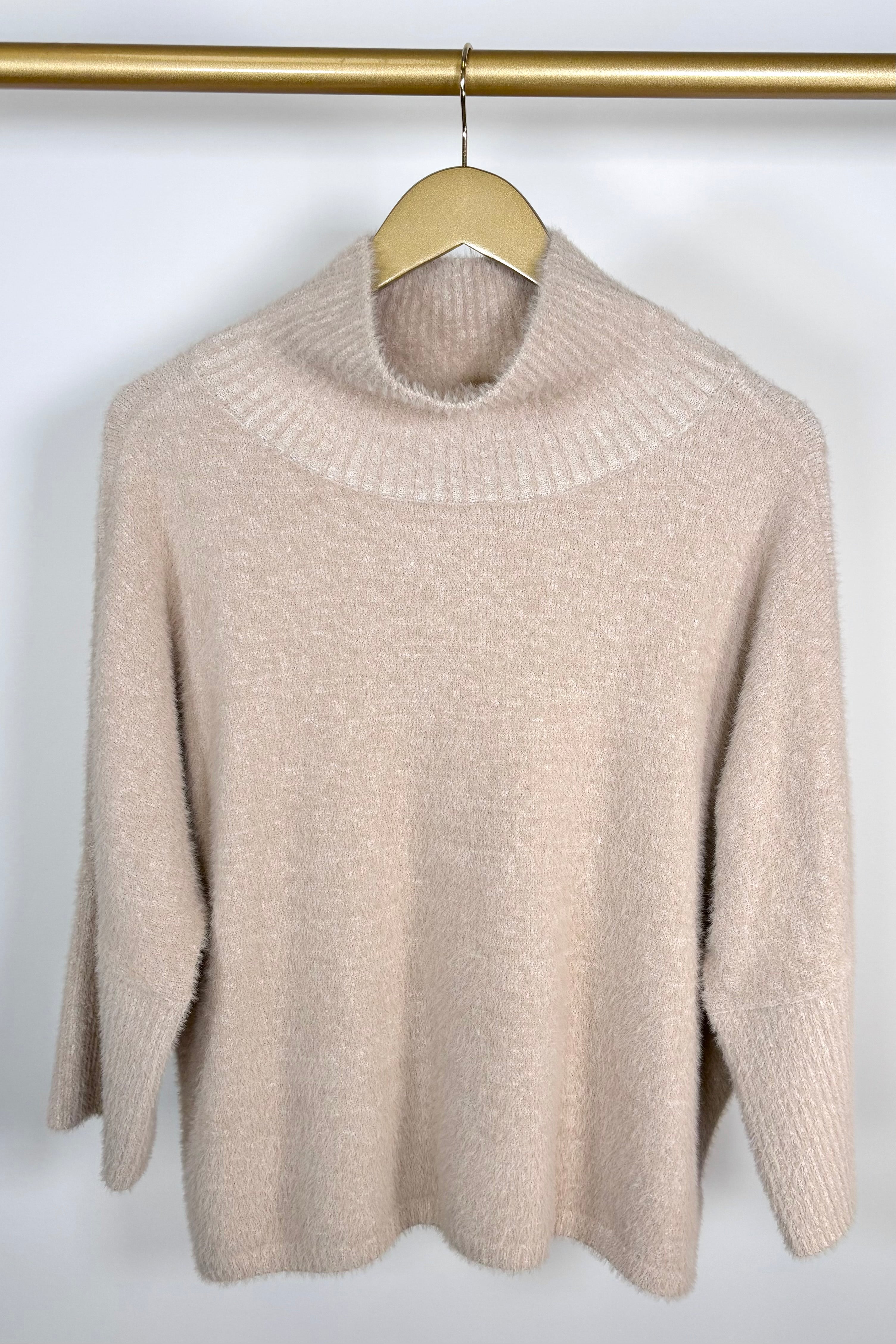 Front view of a mock neck half sleeve hairy cream sweater