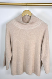 Front view of a mock neck half sleeve hairy cream sweater