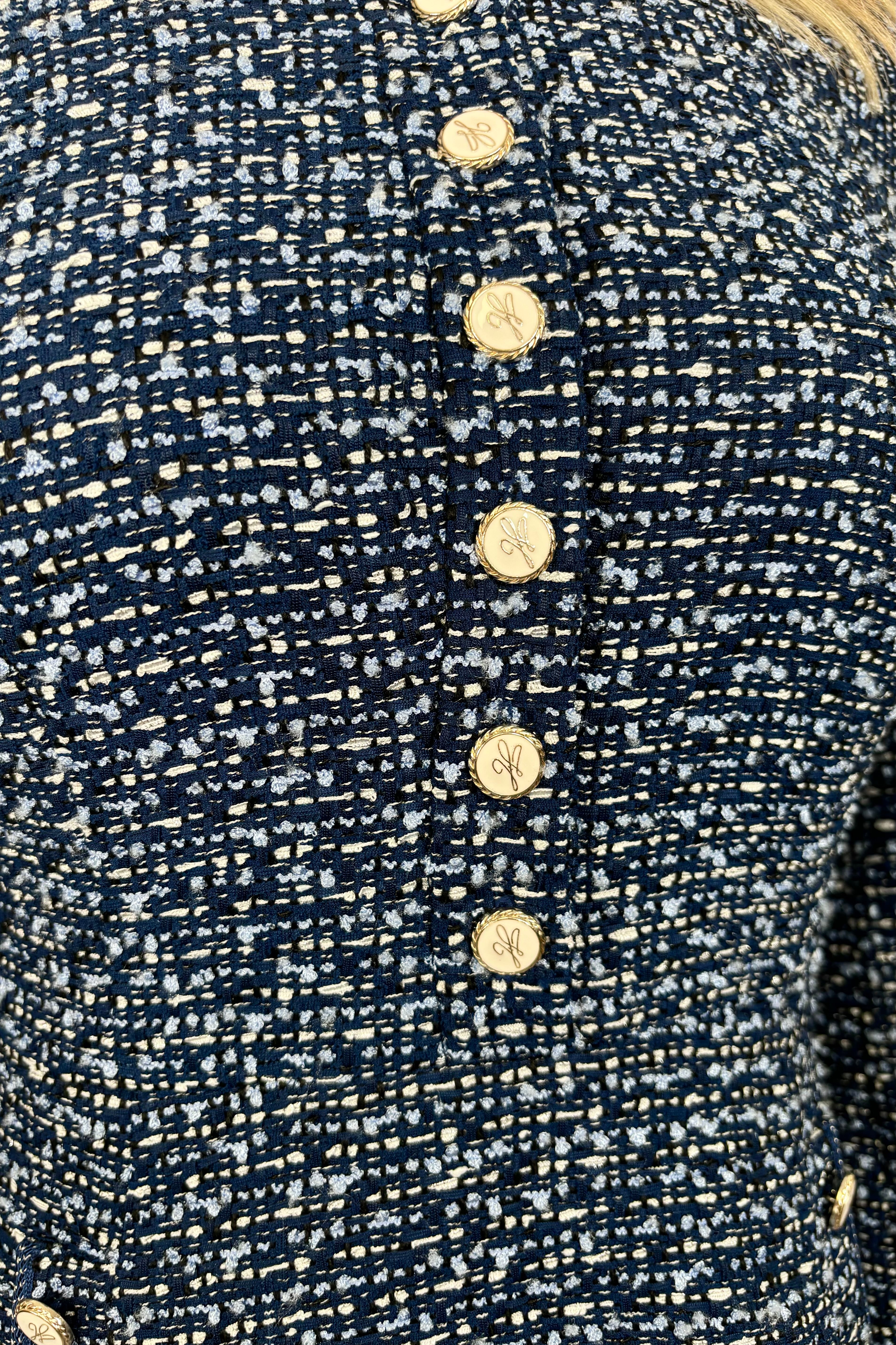 Close-up view of woman wearing a blue tweed short dress