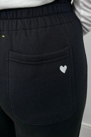 Close up of the back pocket of a wide leg black sweatpant