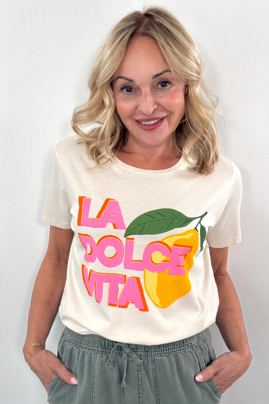 Woman wearing while T shirt with ” la dolce vita” details