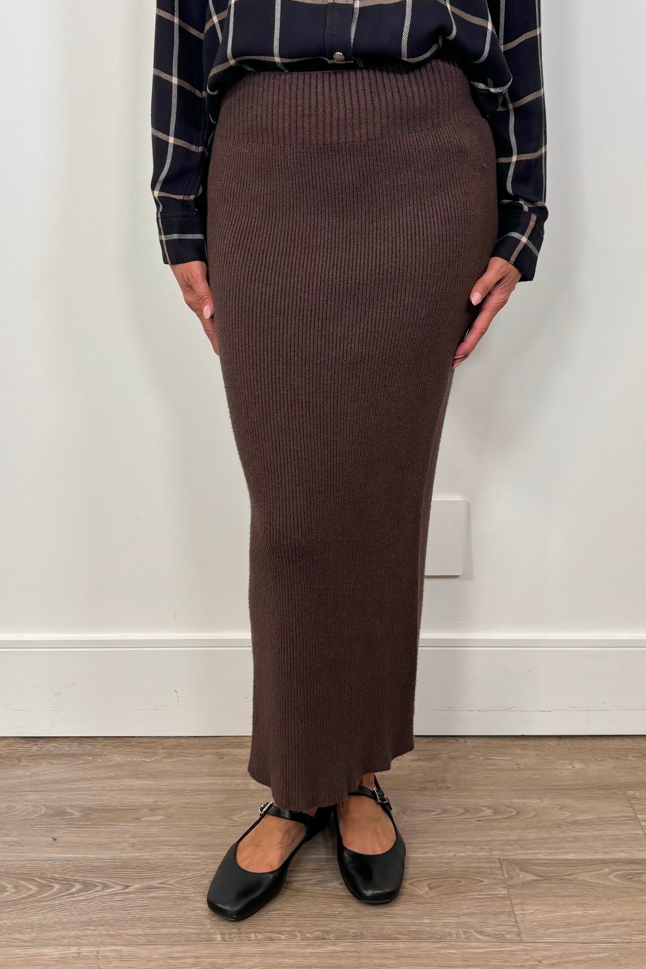 woman wearing a brown ribbed midi skirt
