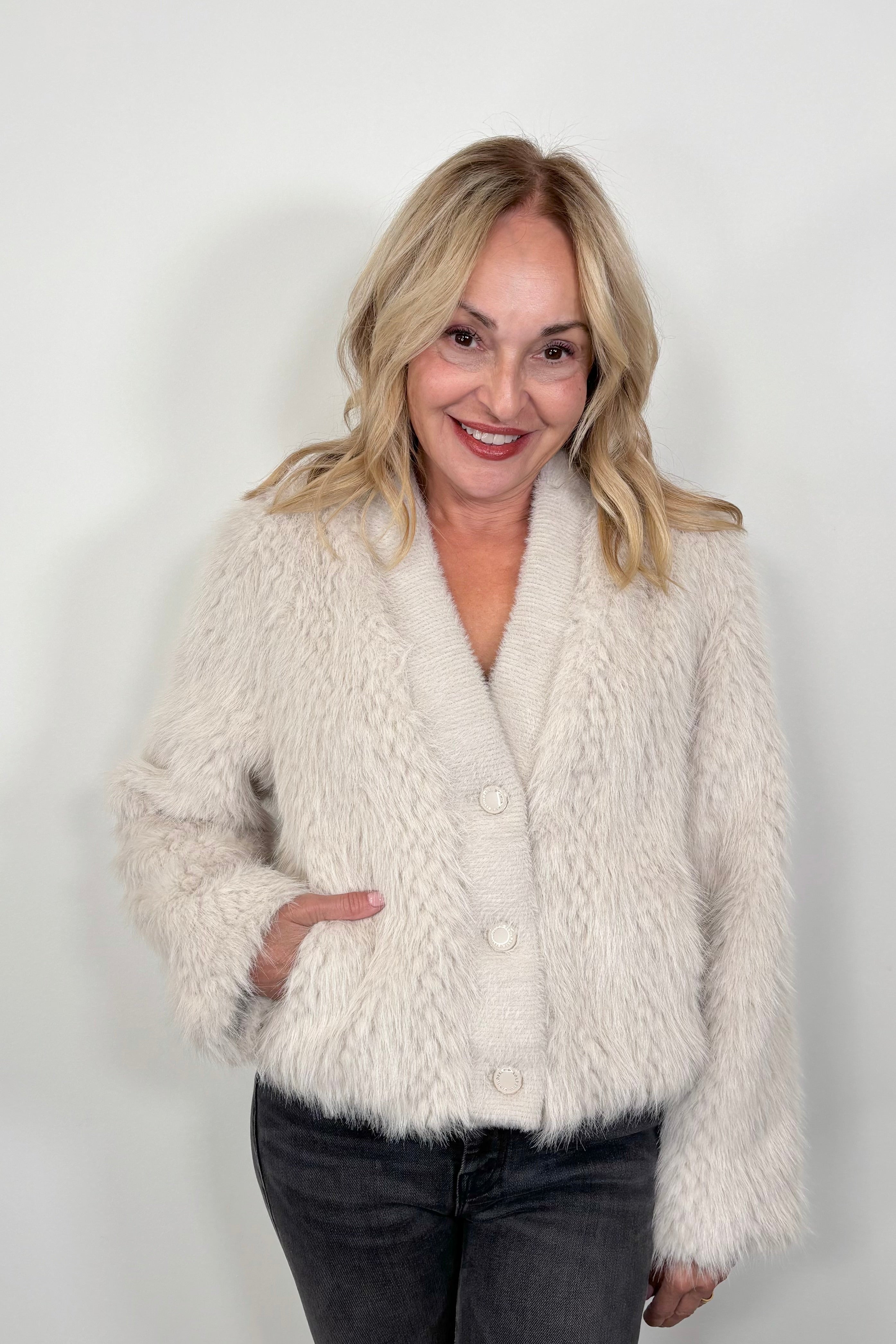 woman wearing a three button cream jacket