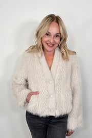 woman wearing a three button cream jacket