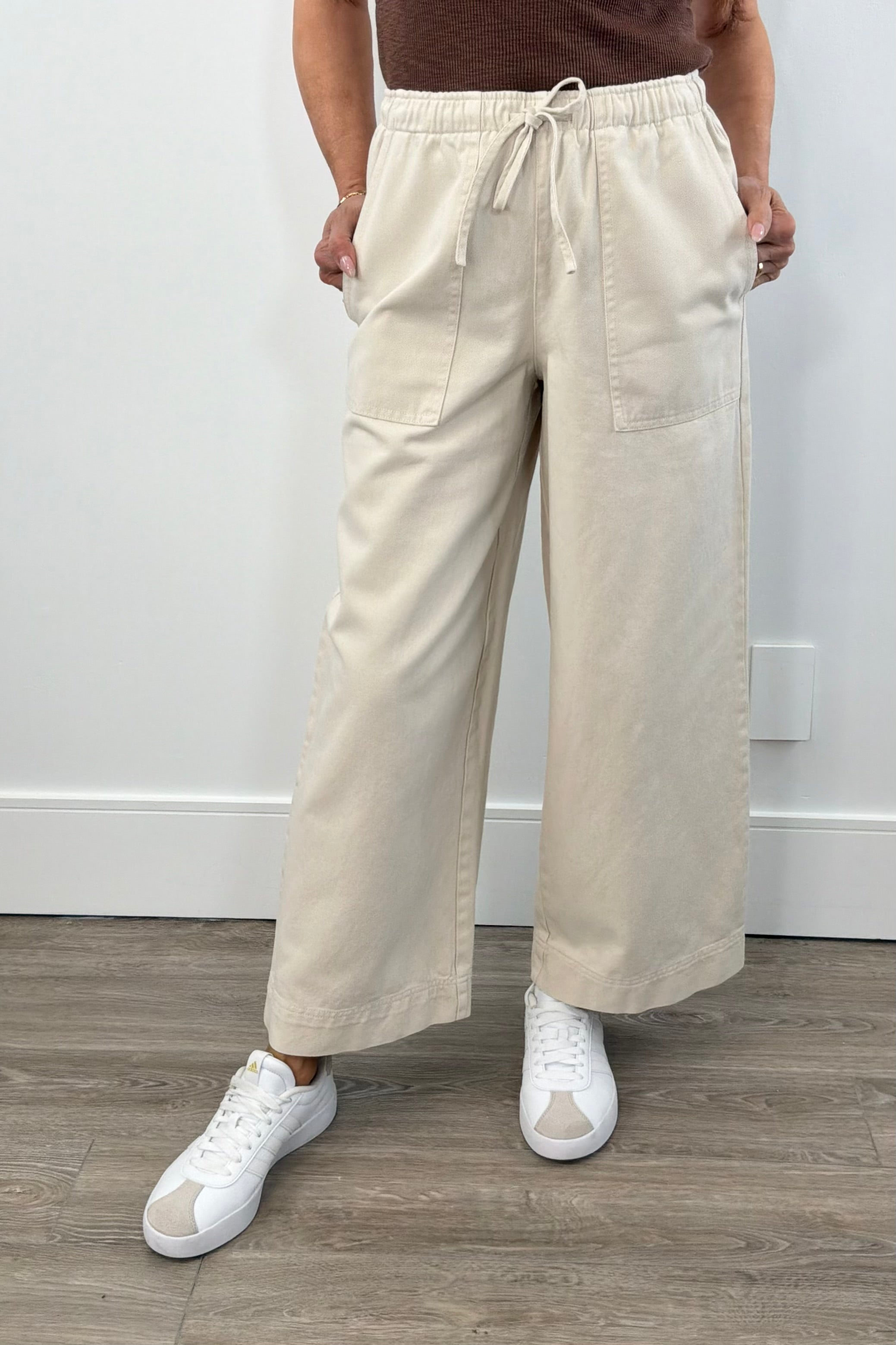 Woman wearing wide leg beige track pants