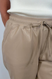 Close-up of a beige leather drawstring pant 
