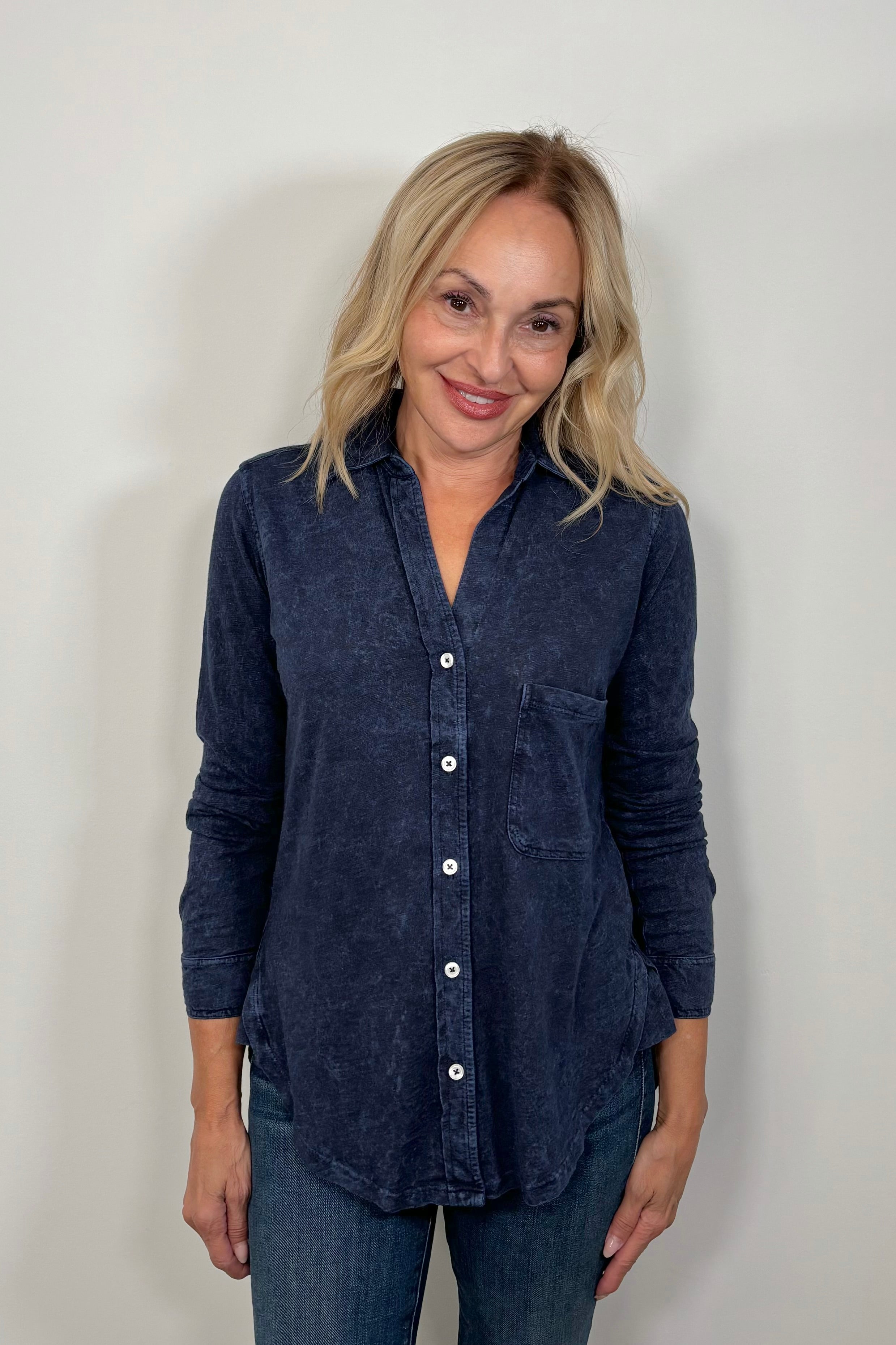 Woman wearing a washed blue button down shirt