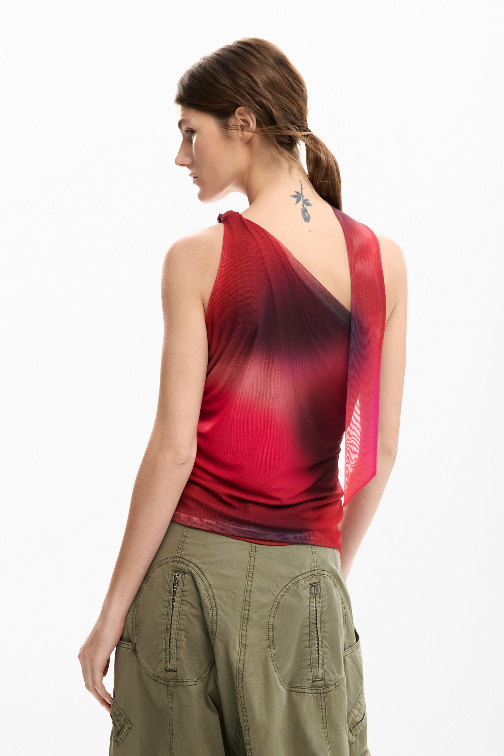 Back view of Woman wearing a dark red over one shoulder top