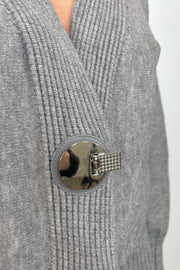 Close up view of the silver hardware of gray cardigan