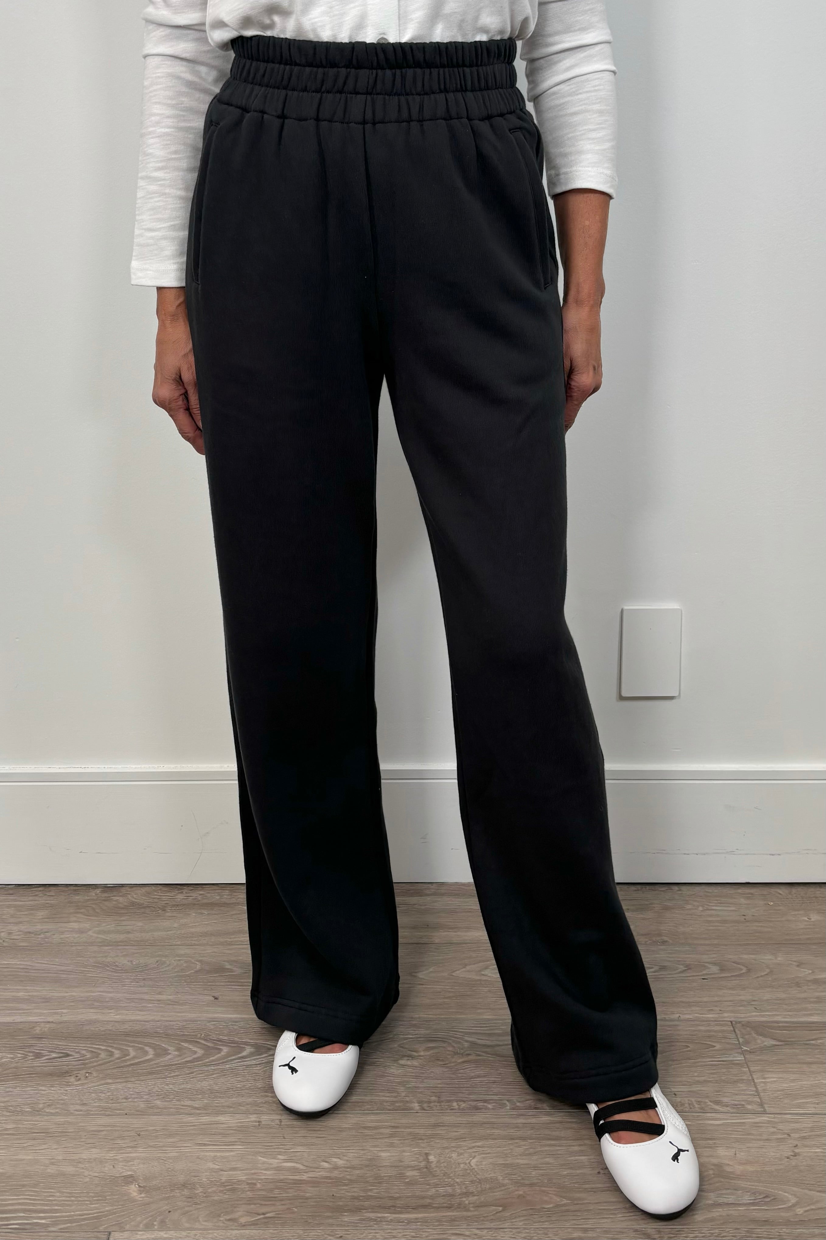front view of a woman wearing a wide leg black sweatpant