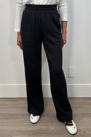 front view of a woman wearing a wide leg black sweatpant