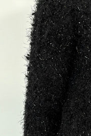 Close-up of black textured cardigan