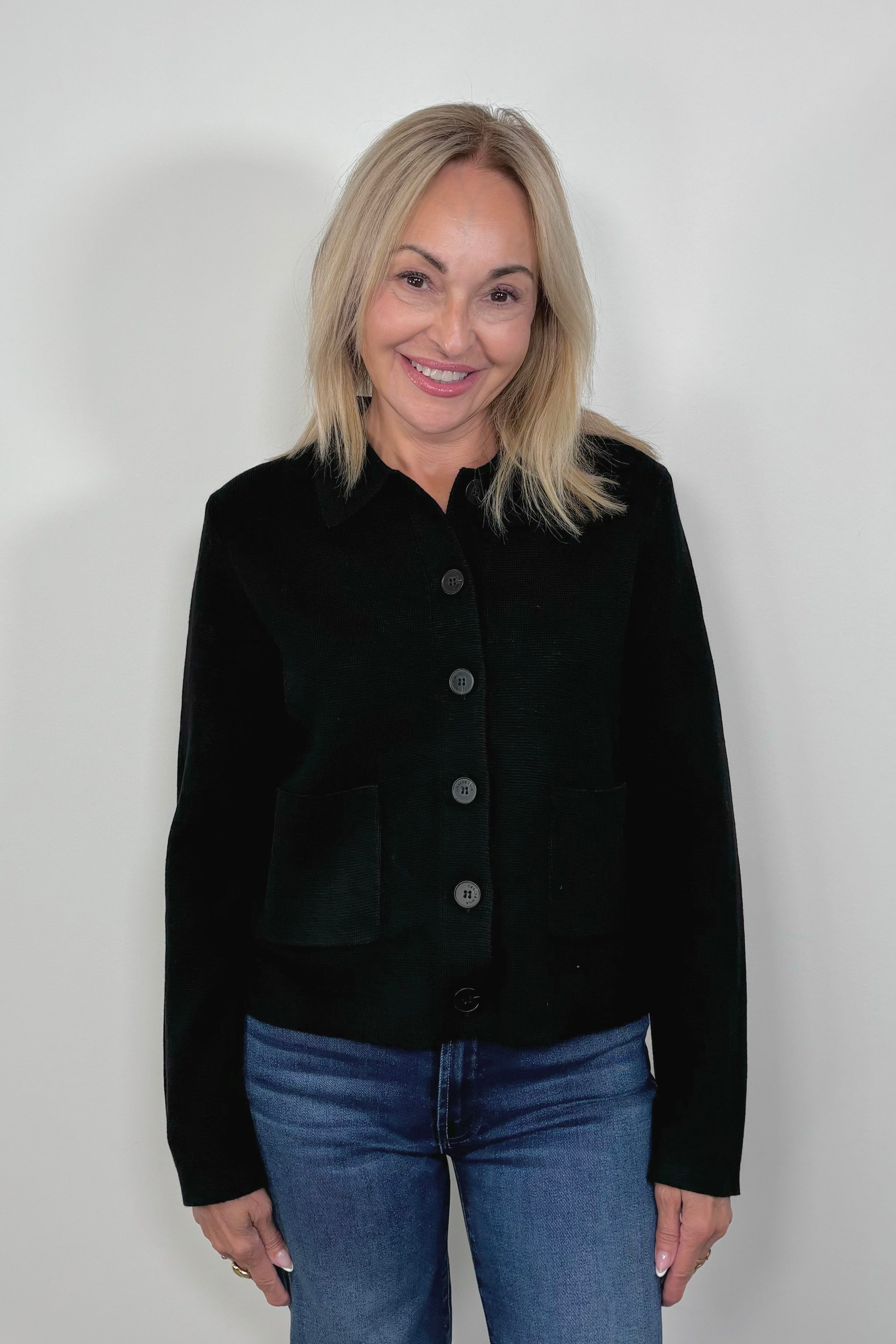 Front view of woman wearing a black cardigan 