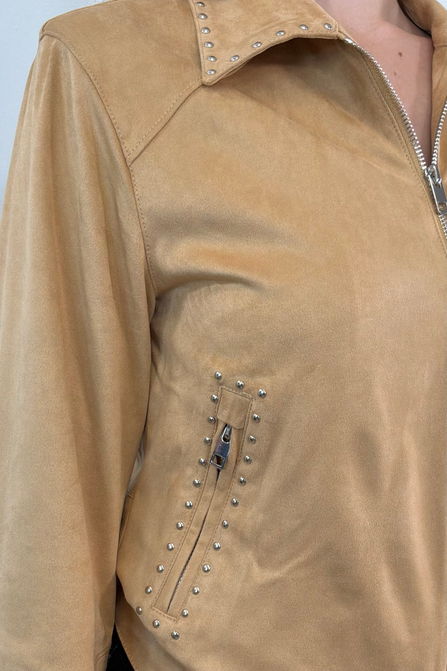 close-up of a faux suede tan leader jacket with stud details