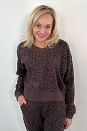 Woman wearing a brown leopard print sweatshirt