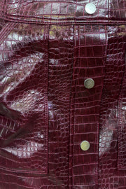 Close-up of a short burgundy button front Russi leather skirt