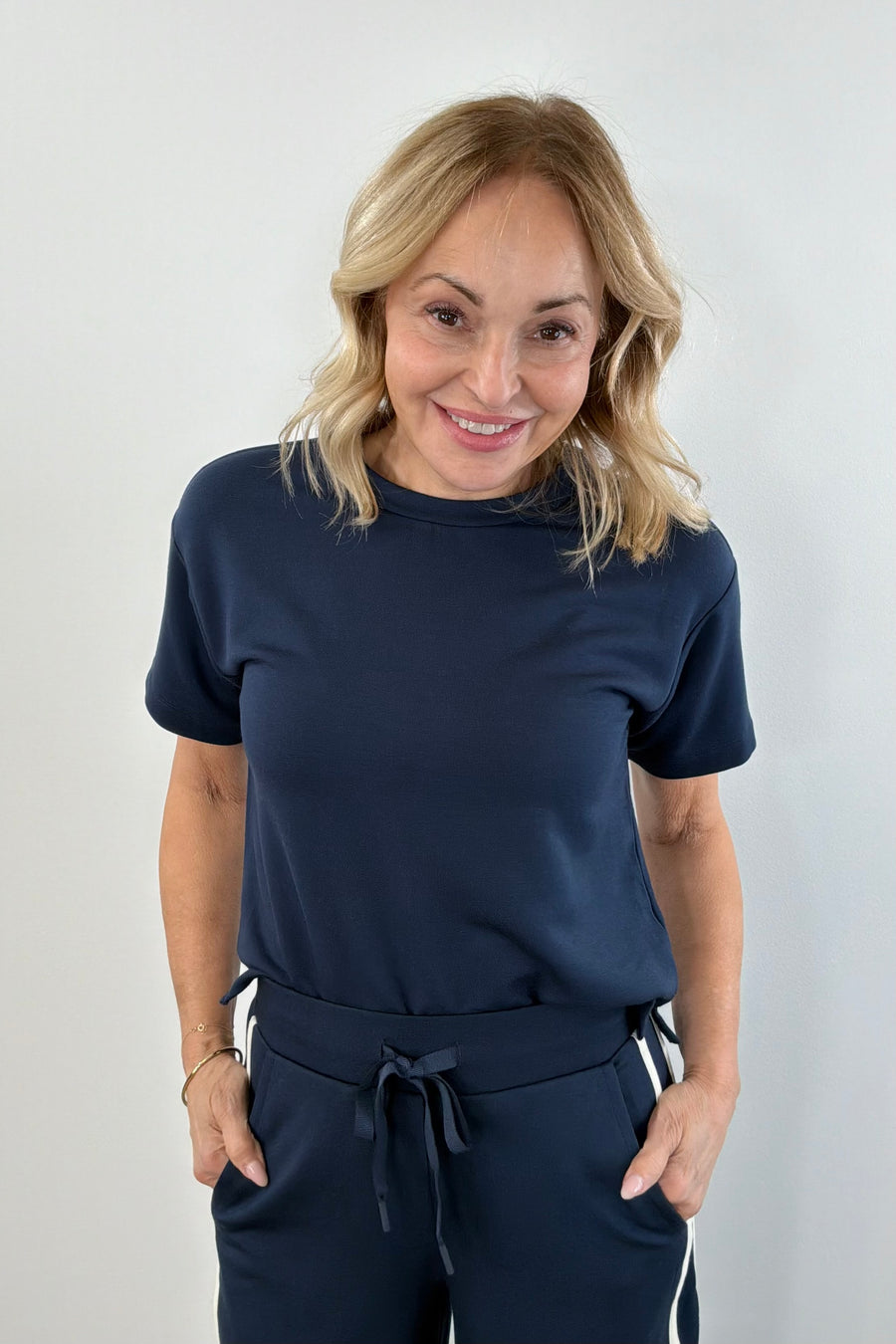 Woman wearing a navy short sleeve knit t-shirt