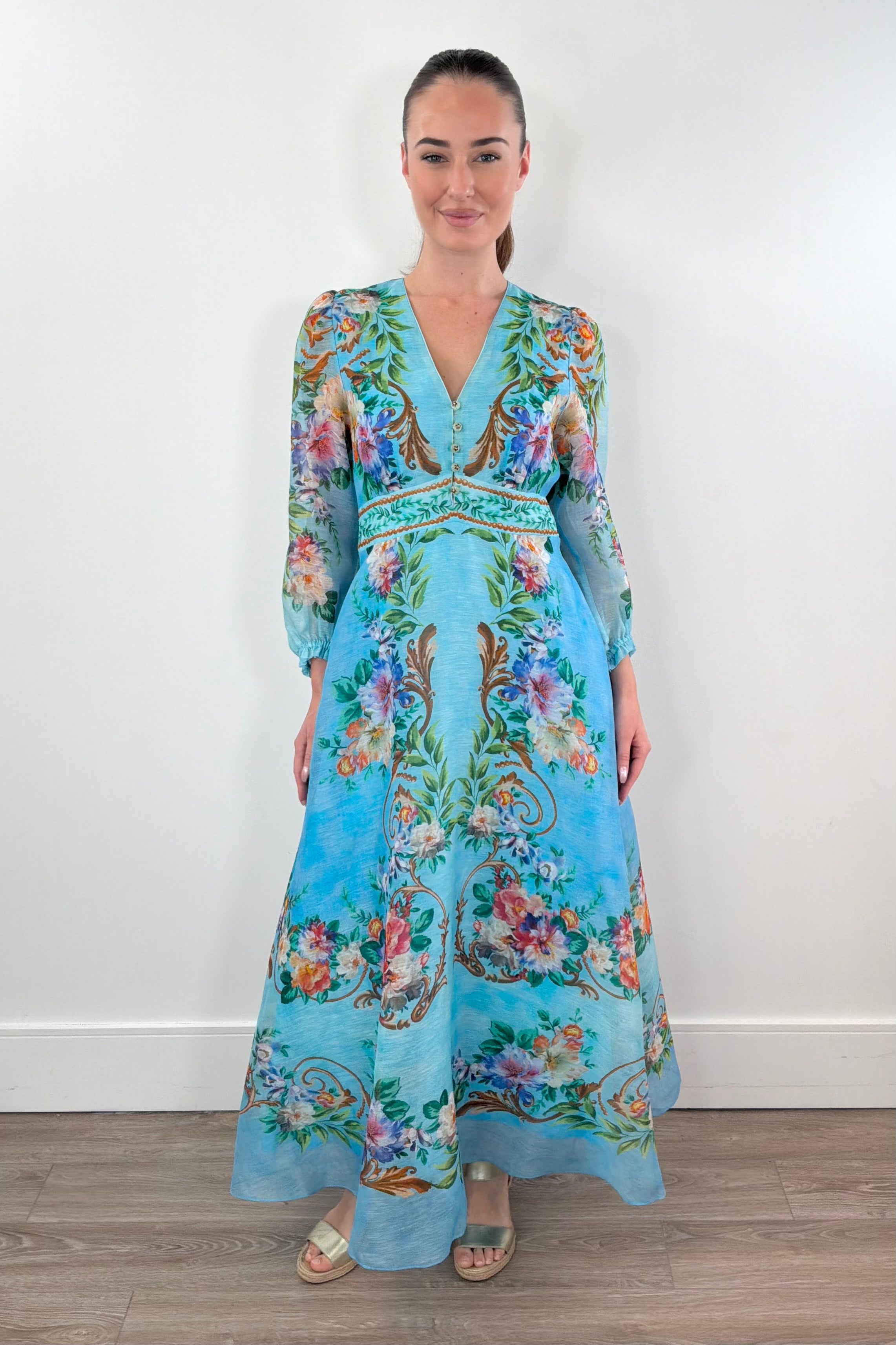 woman wearing a turquoise chiffon floral midi dress