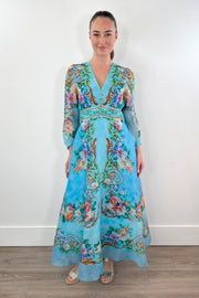 woman wearing a turquoise chiffon floral midi dress