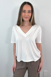 woman wearing a white V-neck top