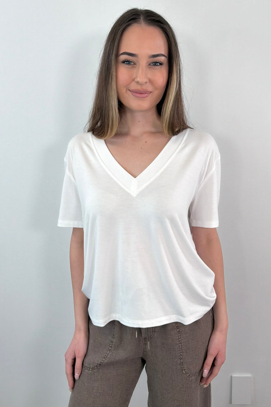 woman wearing a white V-neck top