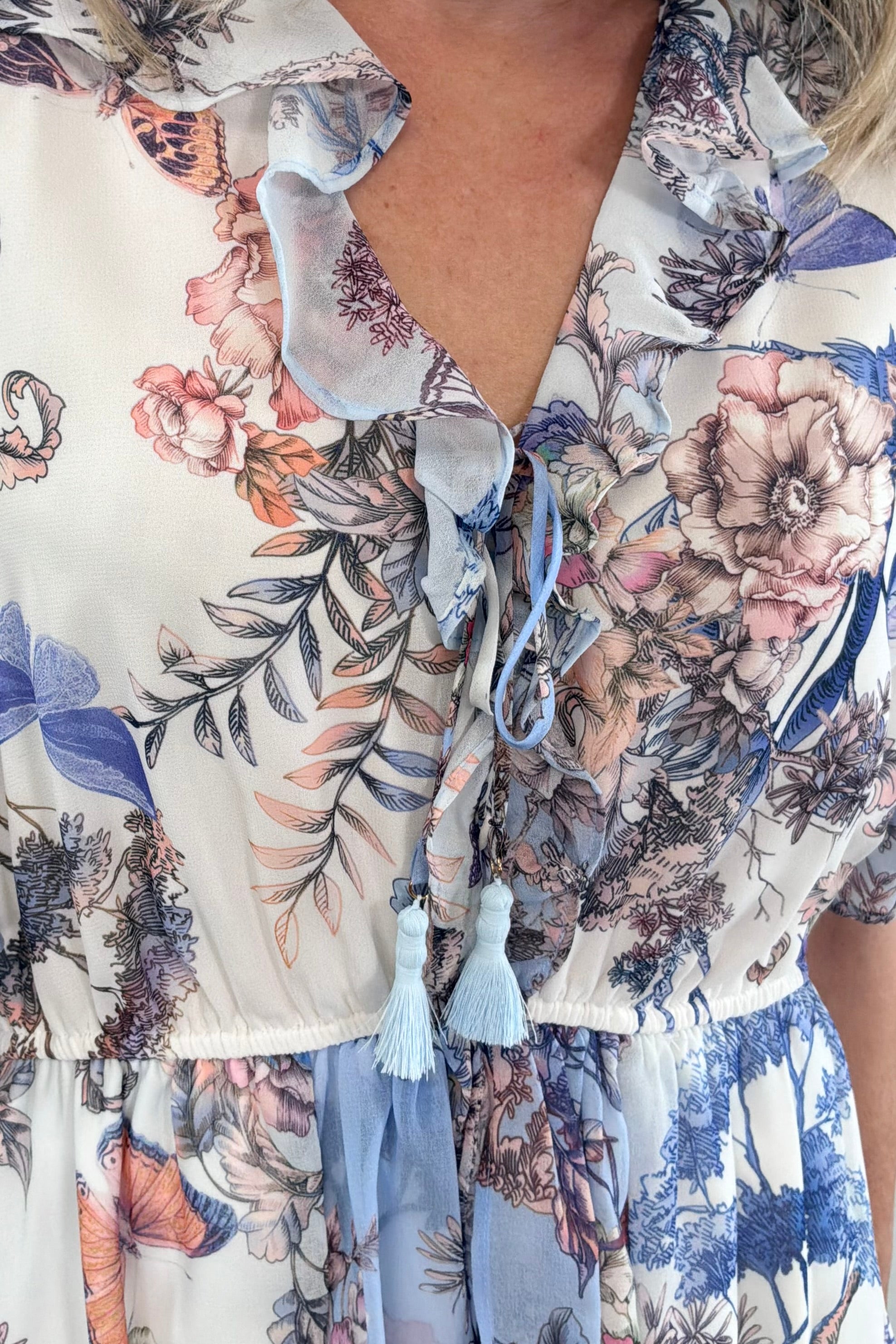 Close up of Woman wearing a blue nature printed dress