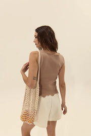 back view of a woman wearing a brown knit sleeveless top