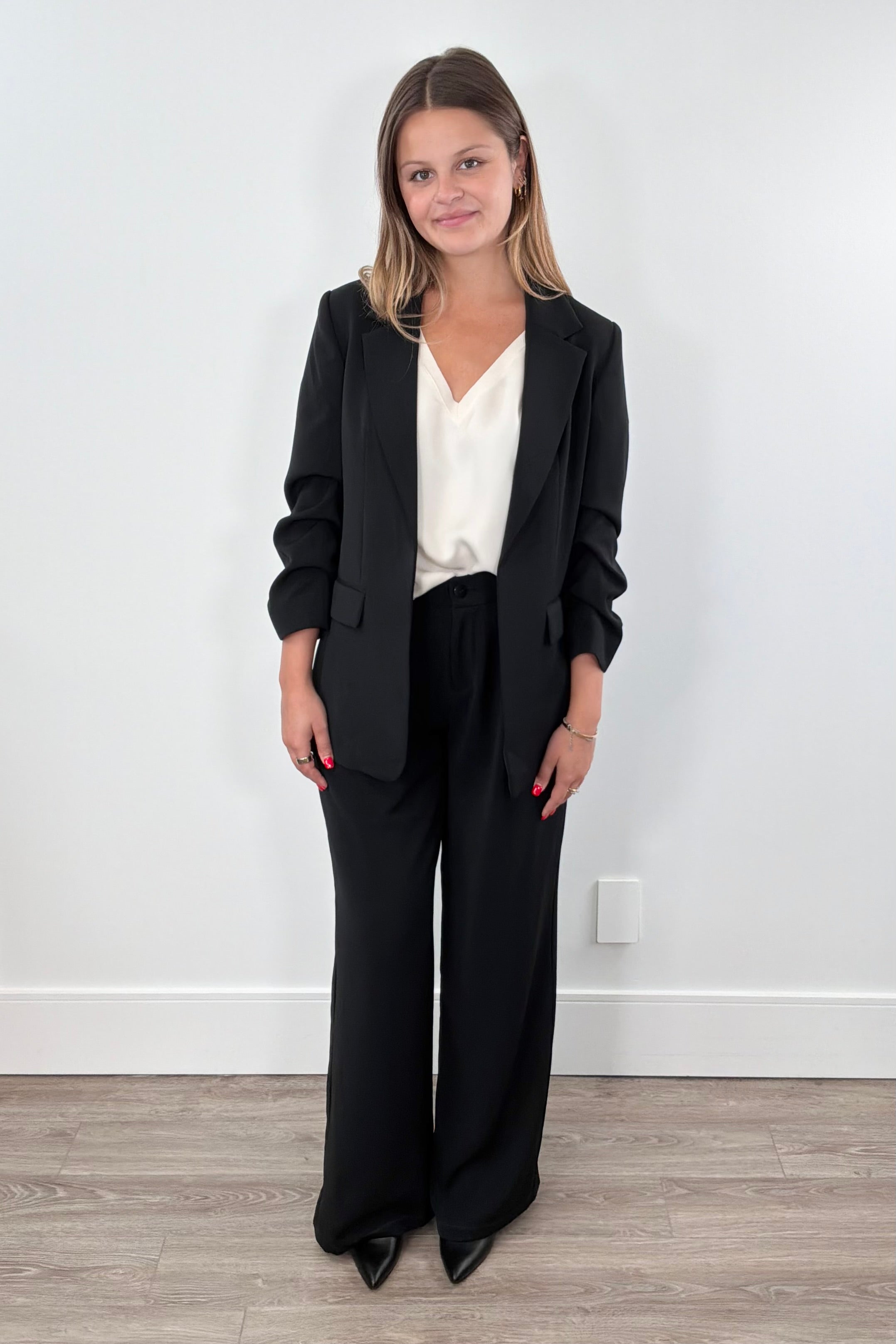 Woman wearing black wide-leg pants. 
