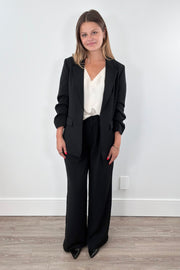 Woman wearing black wide-leg pants. 