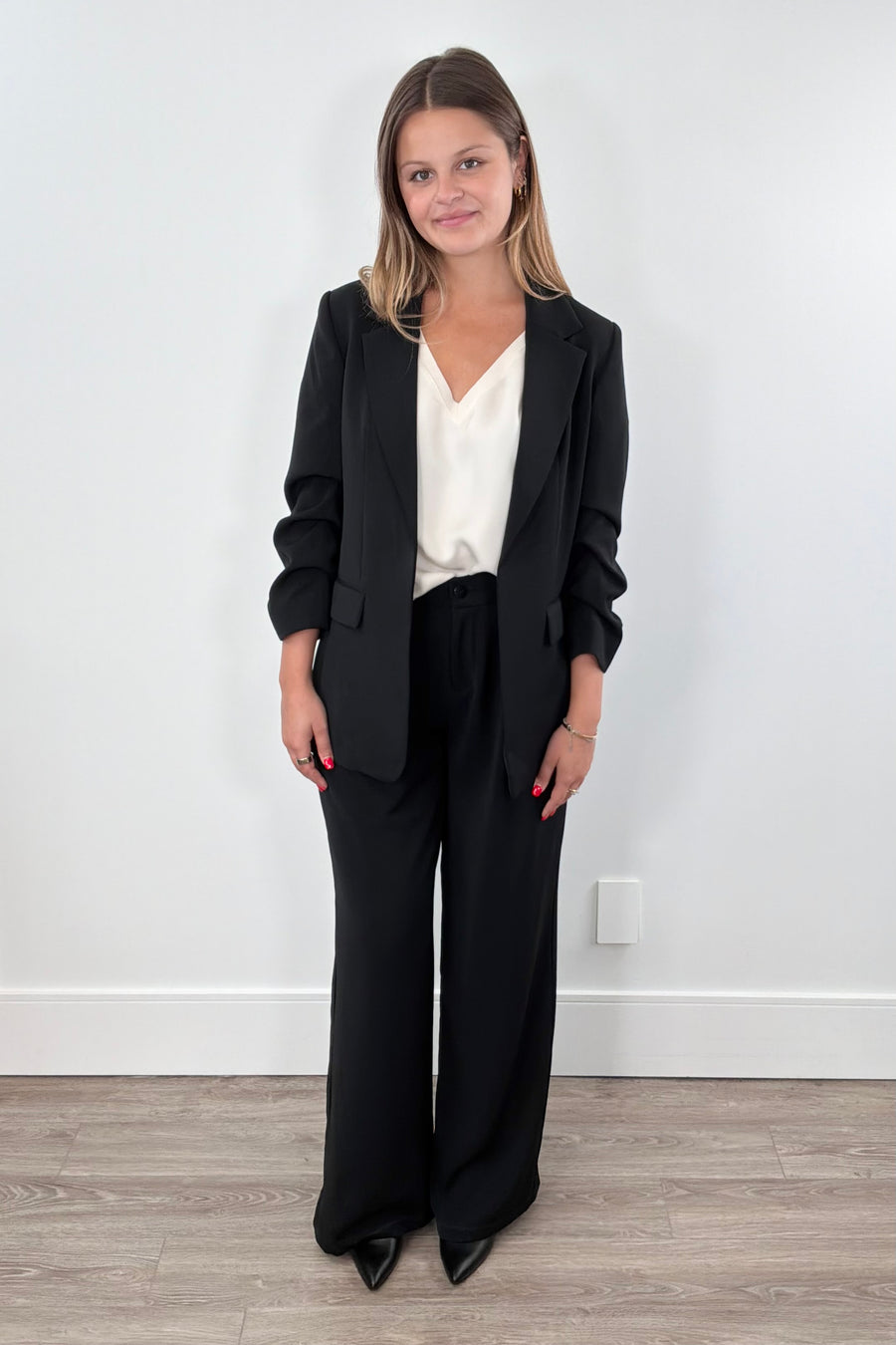 Woman wearing black wide-leg pants. 
