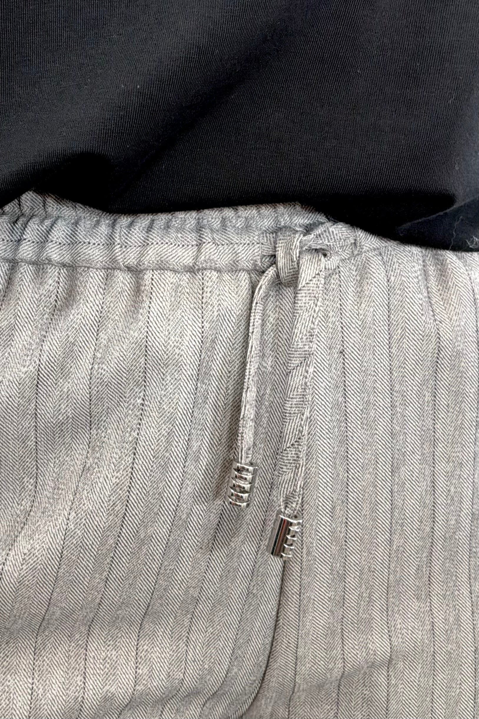 Woman wearing gray pinstripe pants 