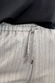 Woman wearing gray pinstripe pants 