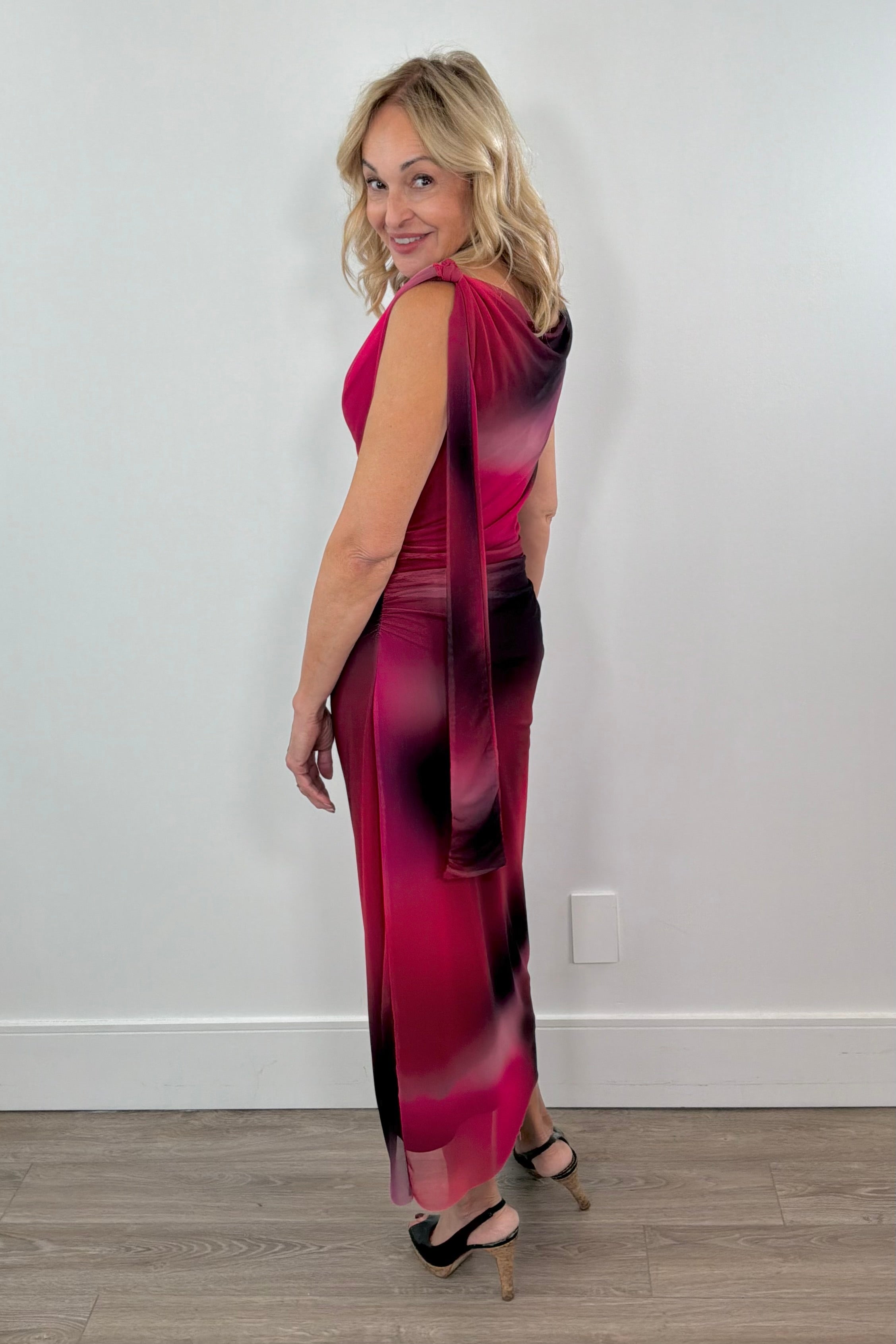 woman wearing a red and black maxi lined mesh dress. with detail in the strap