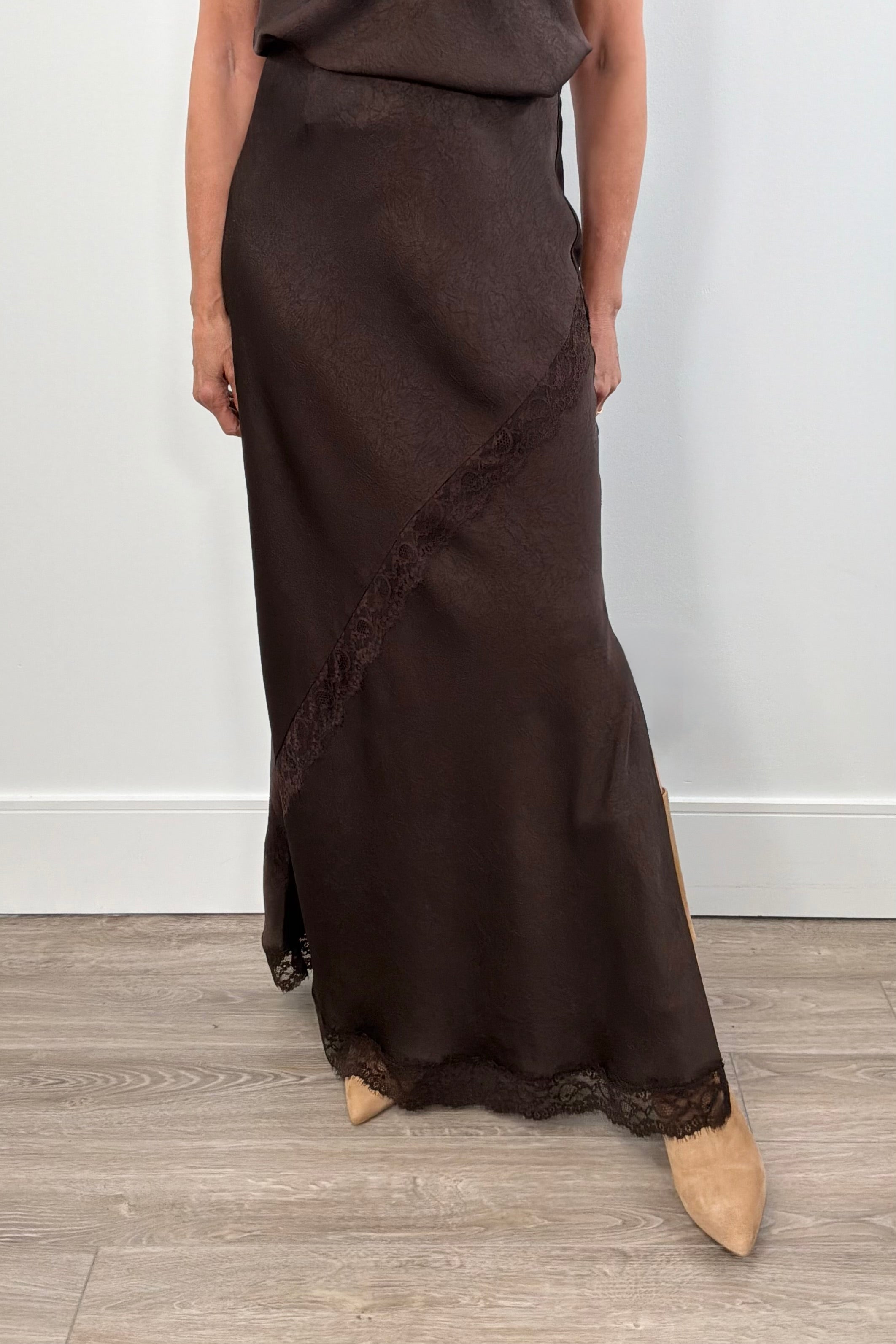 Woman wearing a brown skirt with lace detailing 