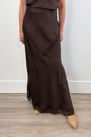 Woman wearing a brown skirt with lace detailing 